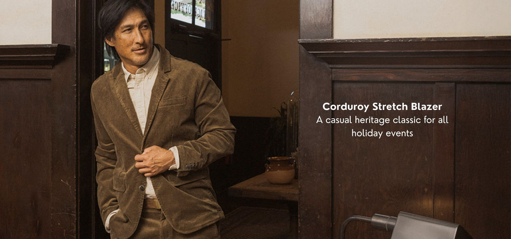 Man wearing a corduroy stretch blazer in a room with wooden furniture.